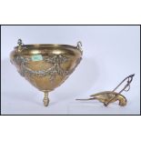 A 19th Century Victorian hanging brass plant holder of conical form decorated in relief with
