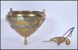 A 19th Century Victorian hanging brass plant holder of conical form decorated in relief with