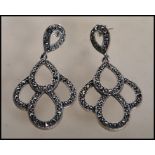 A pair of stamped 925 silver and marcasite drop earrings of teardrop form. Gross weight 11.9g.