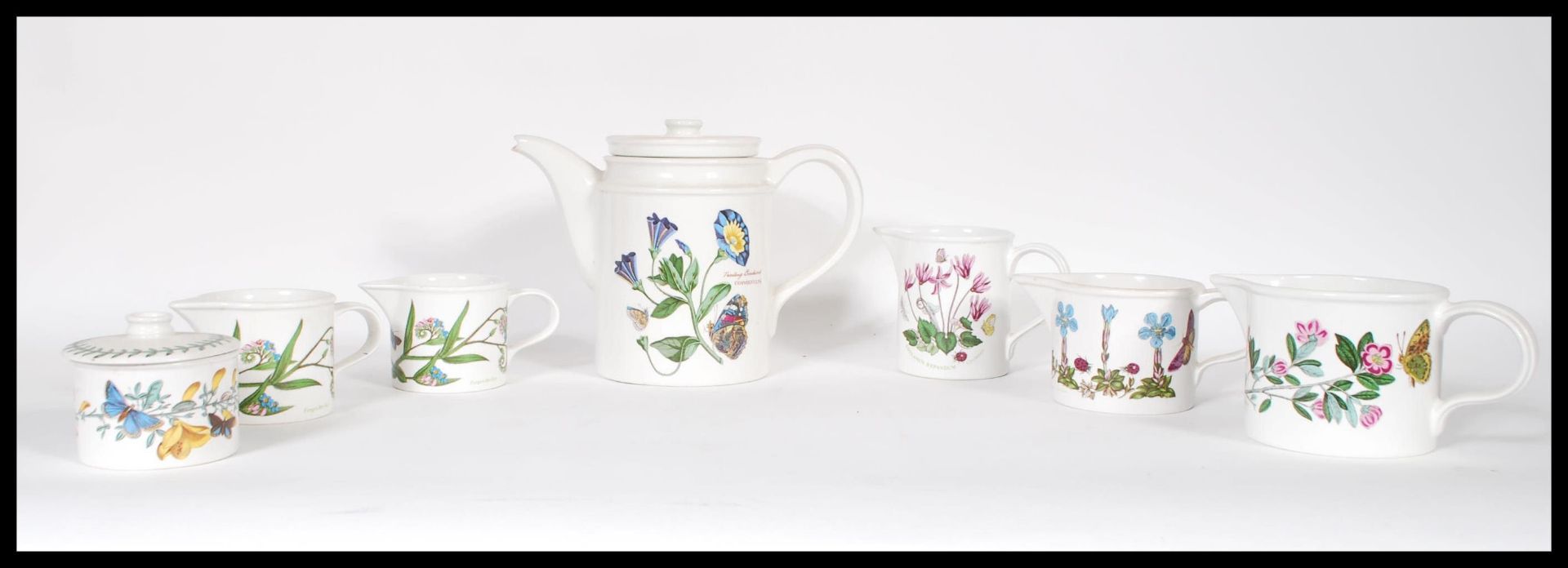 A small collection of Portmeirion Evesham ware ceramics to include teapot, creamers, lidded sugar