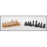 A vintage early 20th Century complete Chess set having boxwood and ebonised pieces complete in