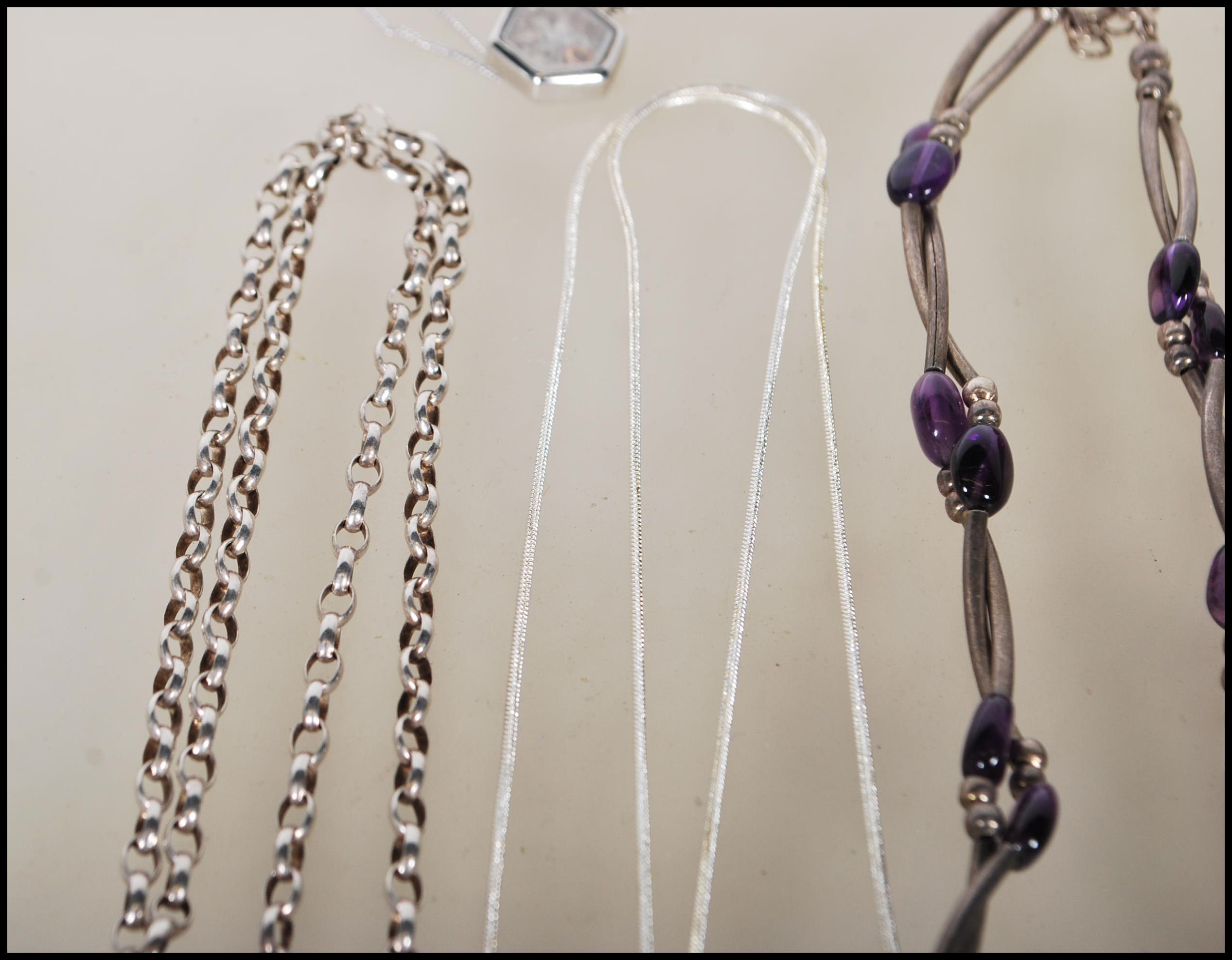 A selection of silver necklaces to include a spacer necklace with purple beads, a snake chain - Image 6 of 8