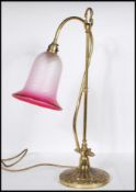 A vintage mid 20th Century swan neck desk lamp raised on a stepped round base with gadrooned and