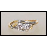 A stamped 18ct gold and platinum Art Deco 1930's diamond ring having two round cut diamonds in a