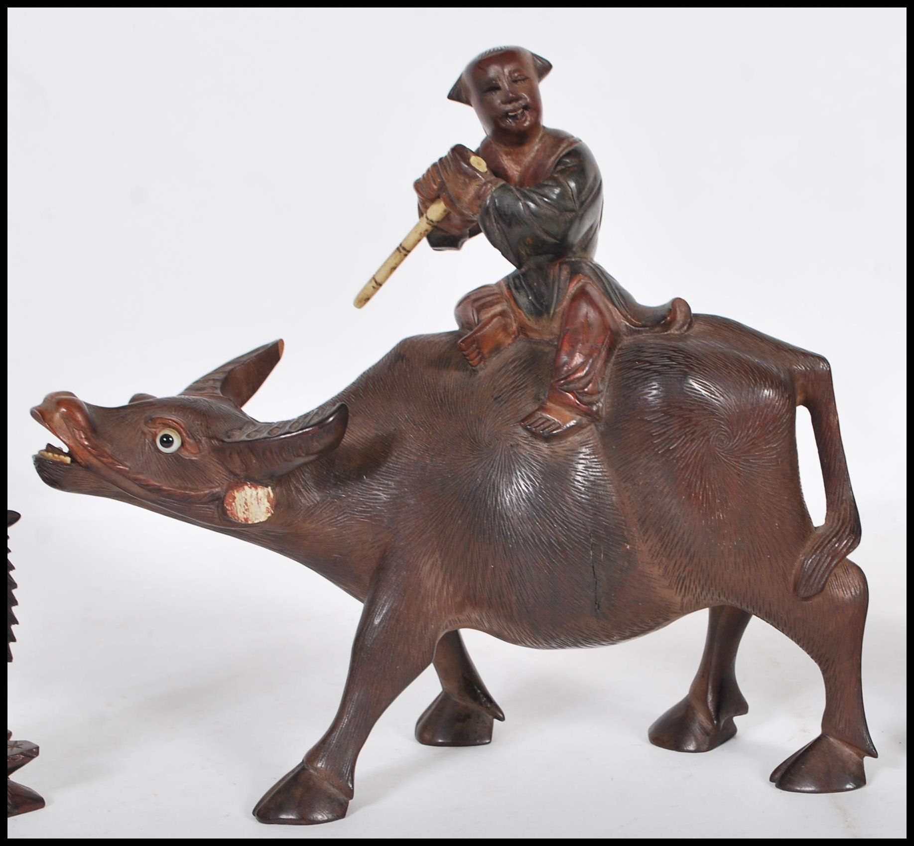 A group of 20th Century Chinese carved hardwood figurines to include a flute player riding on a - Image 3 of 5
