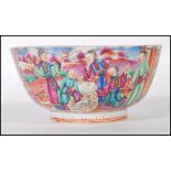 A late 19th Century Chinese bowl having hand painted and enamel figures in a courtyard scenes and