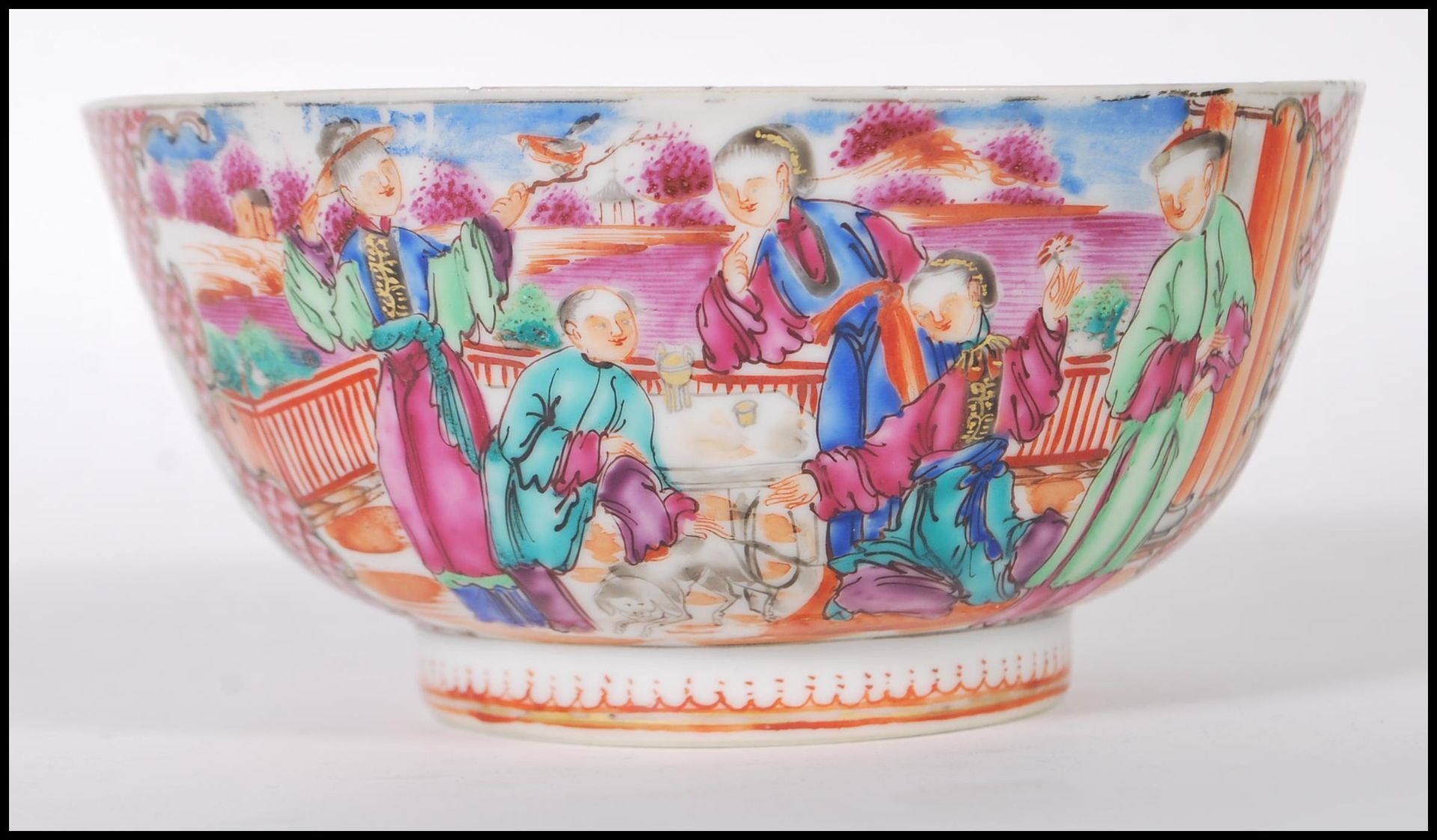 A late 19th Century Chinese bowl having hand painted and enamel figures in a courtyard scenes and