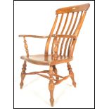 A 19th Century Victorian elm and beechwood Windsor farmhouse elbow chair, lath back above out