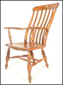 A 19th Century Victorian elm and beechwood Windsor farmhouse elbow chair, lath back above out