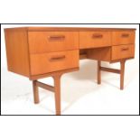 A retro teak wood 20th Century desk / dressing table constructed with a series of drawers with