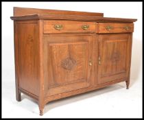 An early 20th Century Edwardian oak sideboard credenza, gallery back with flared top over two reeded