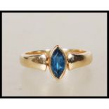 A 9ct gold English hallmarked ring bezel set with a marquise cut blue stone. Assay marked for