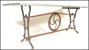A vintage 20th Century upcycled industrial style dining / garden table having cast iron end supports