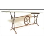 A vintage 20th Century upcycled industrial style dining / garden table having cast iron end supports