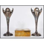 A pair of silver plated Art Nouveau mantelpiece spill vases in the form of opening flowers raised on