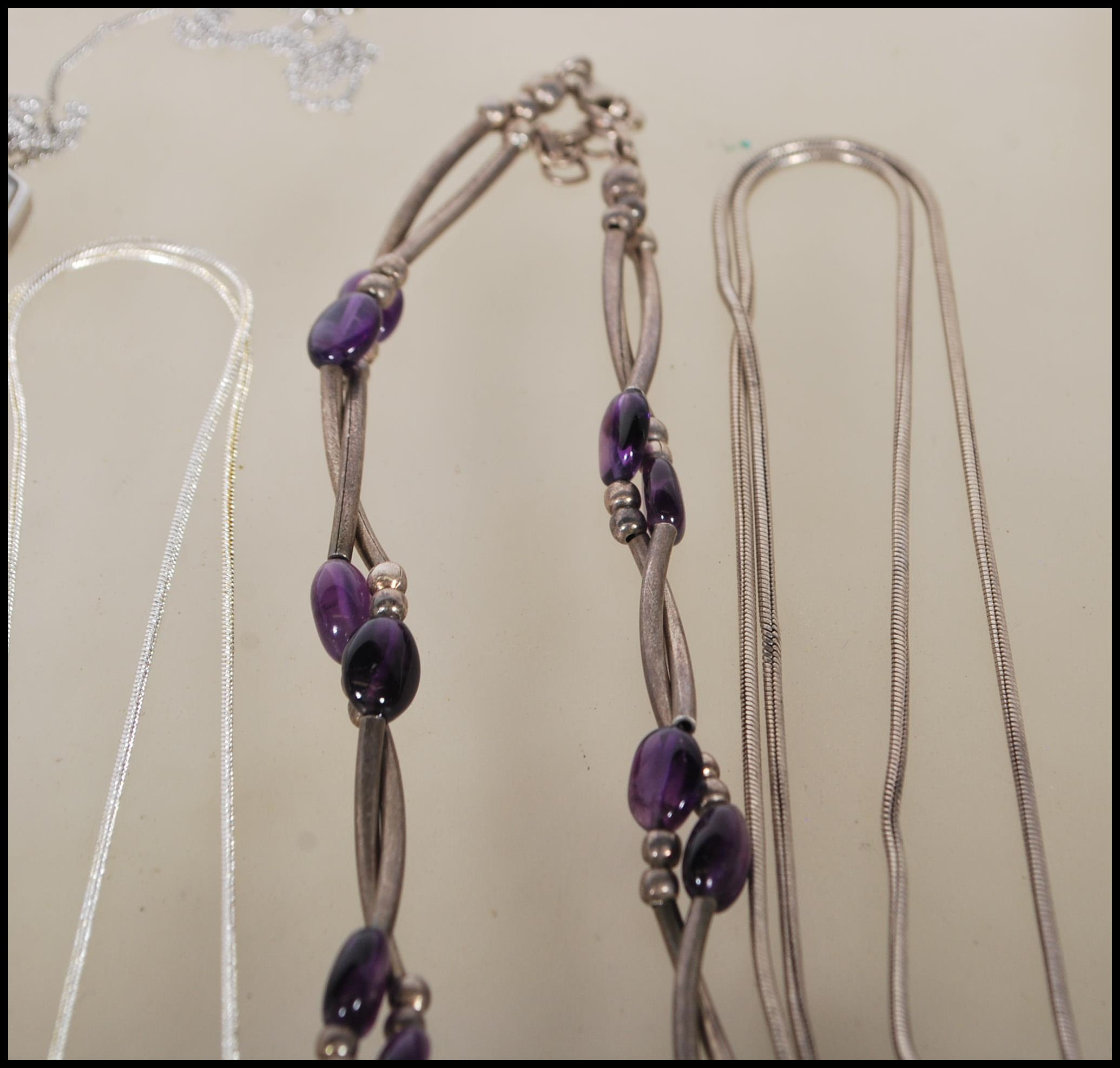 A selection of silver necklaces to include a spacer necklace with purple beads, a snake chain - Image 5 of 8