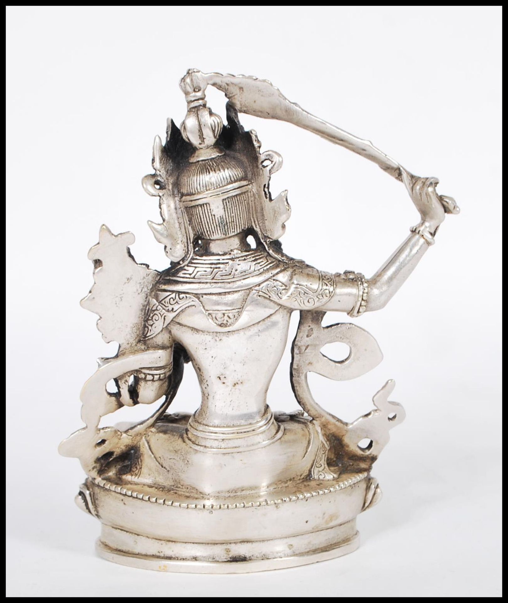 A 20th Century Tibetan white brass figure of Bodhisattva Manjushri seated crossed legged on a - Bild 3 aus 6