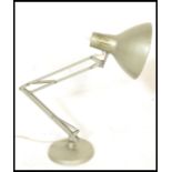 A vintage retro 20th Century 1001 Lamps anglepoise lamp raised on a circular base with conical