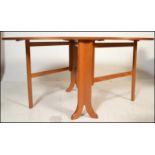 A 1970's 20th century Nathan teak wood drop leaf dining table. The full length drop leaves being