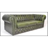 A 20th Century green leather upholstered chesterfield three seater sofa, having buttoned rounded