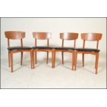 A matching set of four retro 20th Century dining chairs having black vinyl seat pads with shaped