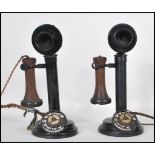 A pair of early 20th Century vintage automatic stick telephones constructed from ebonised cast