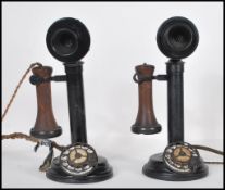 A pair of early 20th Century vintage automatic stick telephones constructed from ebonised cast