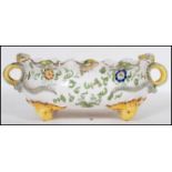 An 19th Century Italian faience centerpiece dish having a fanned rim with curled serpent twin
