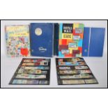 A collection of world stamps over four stamp albums, the stamps dating to the 20th Century, stamps