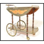 A retro 20th Century Italian style marquetry inlaid two tier drinks trolley with gilt metal mounts