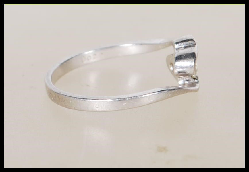 A 950 platinum solitaire diamond ring having an openwork swirl mount set with a single diamond - Image 2 of 6