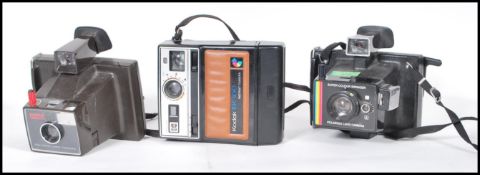 A collection of three original vintage retro polaroid instant cameras / land camera comprising: A