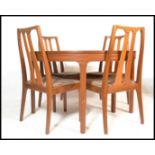 A retro 20th Century teak wood extendable dining table and matching chairs by Nathan, the circular