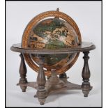 A 20th Century antique style desktop celestial globe raised on a gimbal stand with turned legs