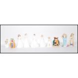 A collection of ten ceramic pieces to include Royal Doulton figurines to include Make Believe