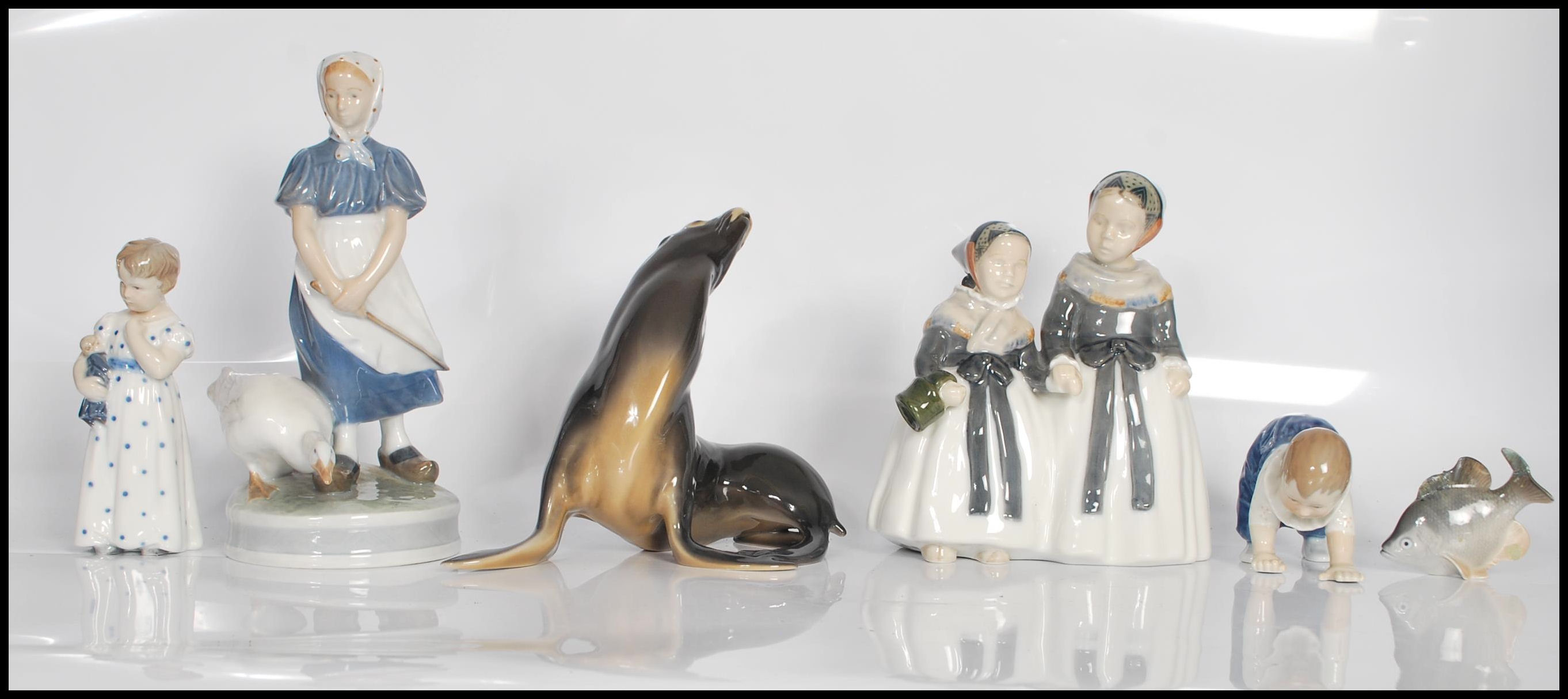 A collection of Royal Copenhagen figurines to include no. 1316 figure group of two milk maids, no.