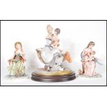 A collection of three Capodimonte figure groups to include two breast feeding mothers on