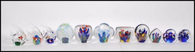 A selection of glass paperweights depicting swimming fish, most of domed form possibly by Murano.