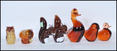 A collection of seven retro 20th Century glass paperweights modelled as animals such as an elephant,