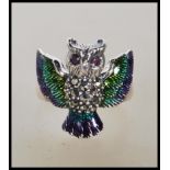 A stamped 925 silver ladies dress ring in the form of a owl having enamel plique a jour wings and