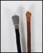 A 20th Century malacca walking stick having engraved geometric decoration to the shaft with a carved