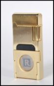 A gold tone rectangular Ronson cigarette lighter having a striped textured body with fold out