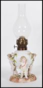 A 19th Century German Sitzendorf floral encrusted winged cherub / putti porcelain oil lamp set