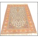 An early 20th Century persian style floor rug carpet, large central ornate panel surrounded by