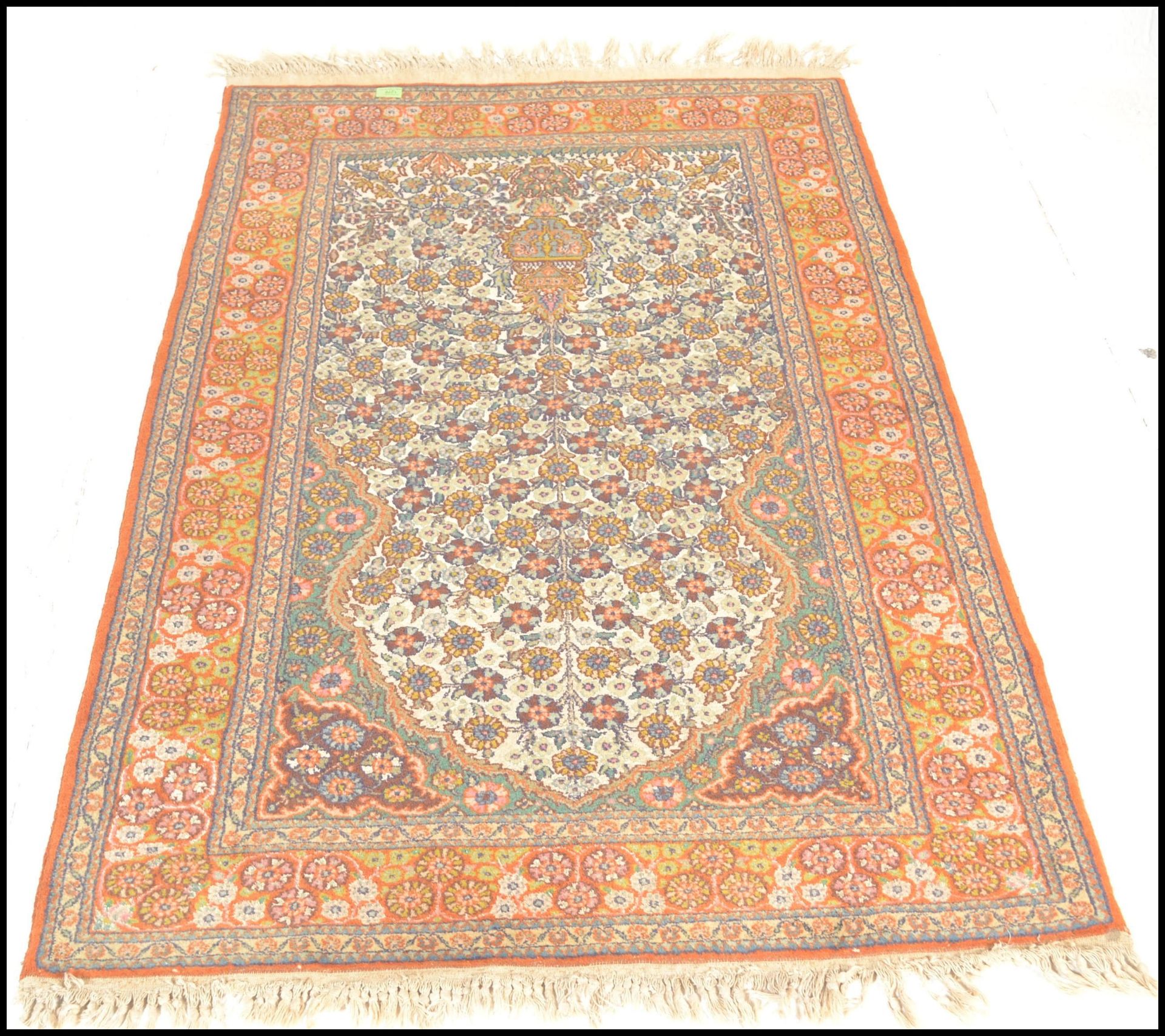 An early 20th Century persian style floor rug carpet, large central ornate panel surrounded by