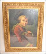 A 20th century framed and glazed print of a Victorian painting depicting a boy with hat and red