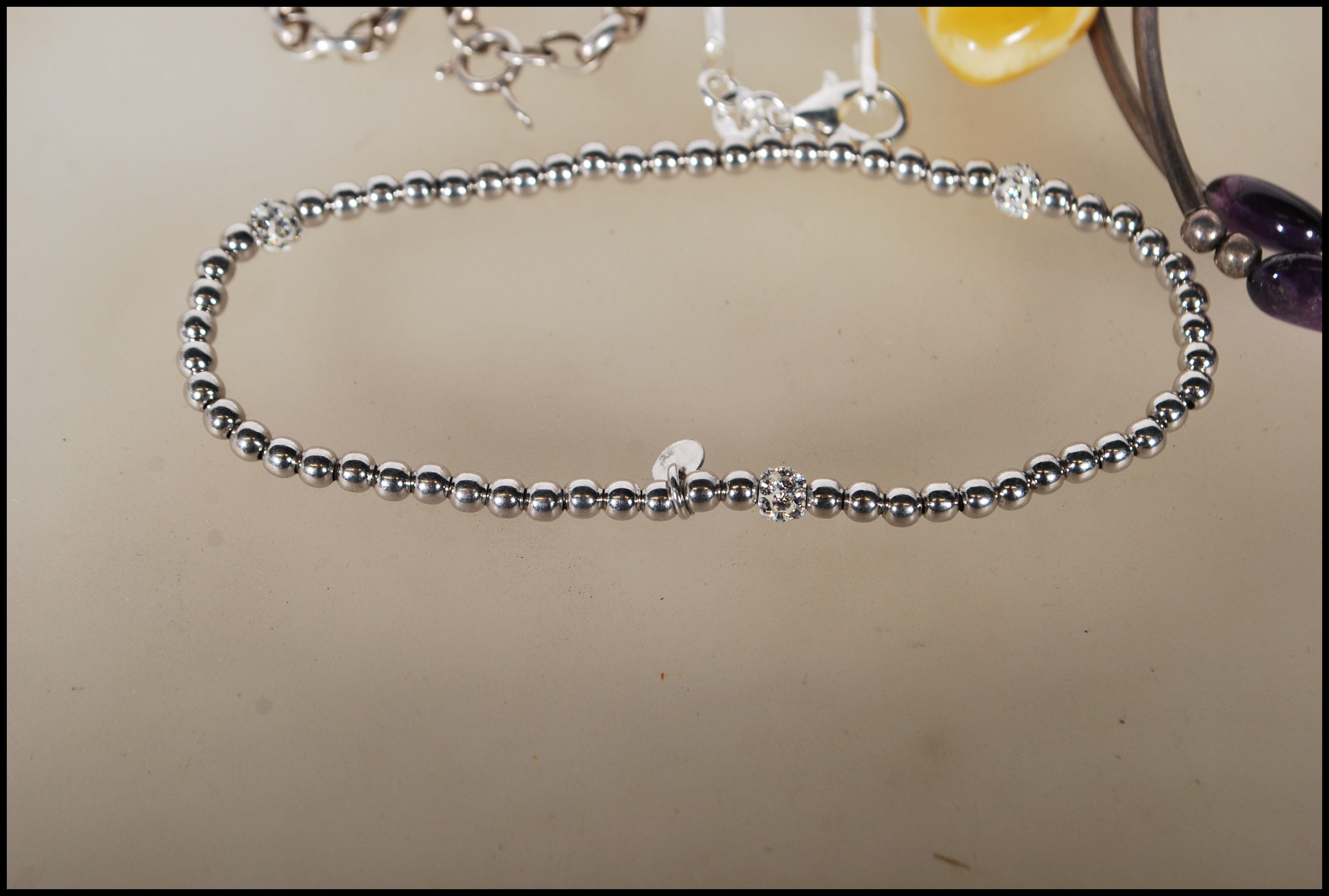 A selection of silver necklaces to include a spacer necklace with purple beads, a snake chain - Image 2 of 8