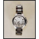 A contemporary Michael Kors chronograph wrist watch having a round white enamelled face with roman