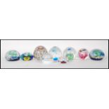 A collection of eight 20th Century glass studio paperweights to include an example by Murano