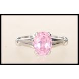 A stamped 9k 375 white gold single stone dress ring having central faceted prong set pink stone with